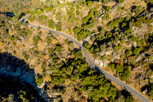 Aerial image of a road going through on a hill side.