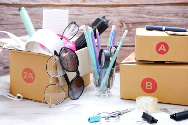 istock Preparing parcels for shipment to customers on table in home office,Parcel cardboard box packing on table 1270867363