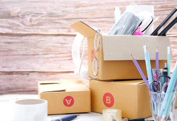 istock Preparing parcels for shipment to customers on table in home office,Parcel cardboard box packing on table 1270867398