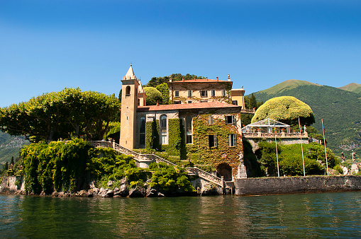 The Villa Balbionelli with its terraces and gardens in Lake Como. The terrace walls have carved balustatrades the villa is open to the public and has a terraced garden with trees and flower beds