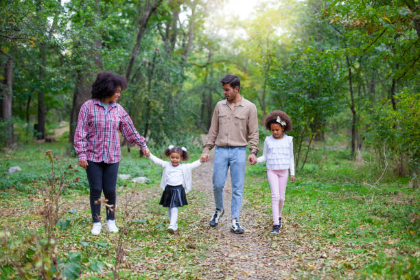 istock Happy family walking along a path in the woods 1270868194