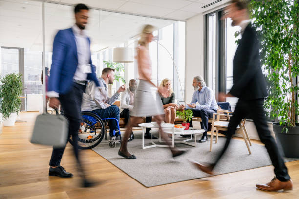 istock Business executives on the move through modern office 1270868328