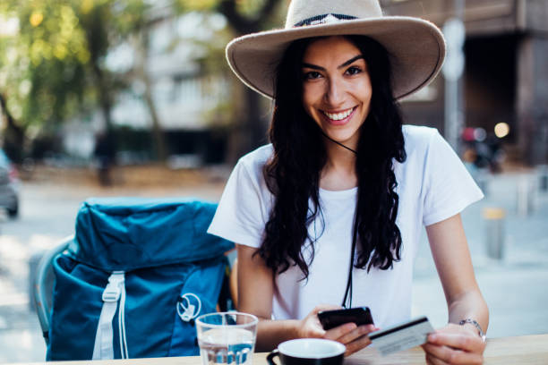 istock Beautiful tourist taking a break and shopping online 1270868398