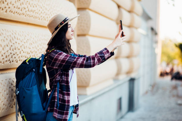 istock Happy girl on a journey sightseeing and  taking a selfie 1270868414
