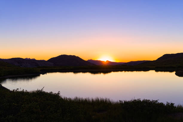 istock Mountains Sunset Reflections in High Alpine Tarn 1270869652