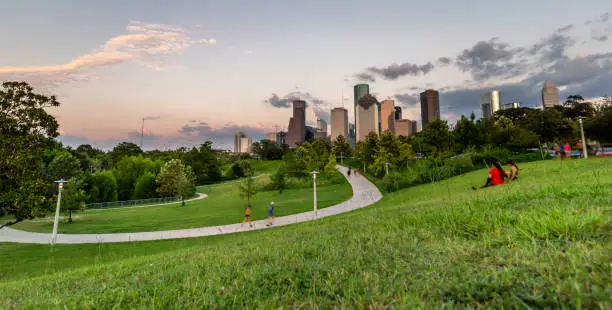 Photo of Low Angle View of Downtown Houstin From Large Park During Summer Sunset