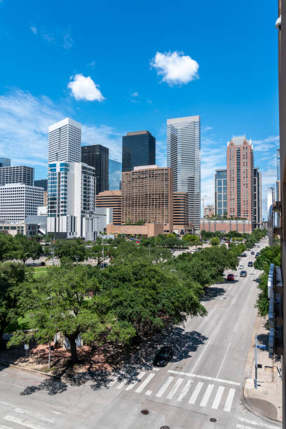 Vertical View of the Streets of Houston With Mostly Clear Skies Vertical View of the Streets of Houston With Mostly Clear Skies city street street corner tree stock pictures, royalty-free photos & images