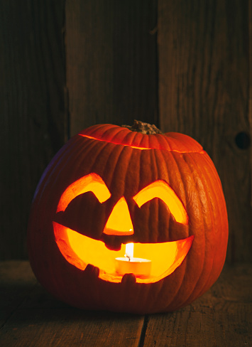 Halloween Jack O' lantern on rustic wooden background