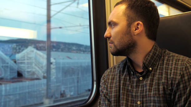 istock Confident serious man looks out the window of a train 1270876003