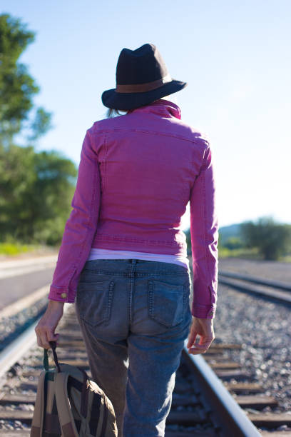 istock Woman in Pink Walking Down Train Track 1270878247