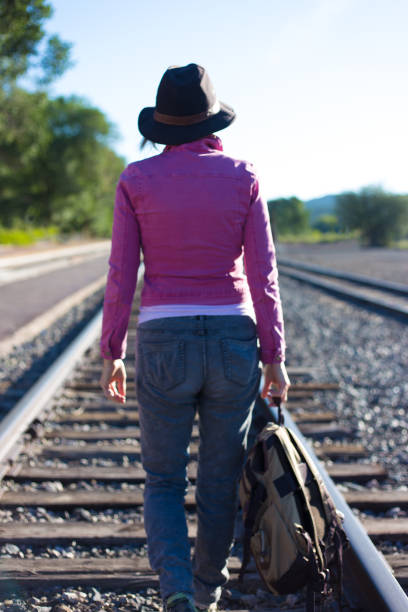 istock Woman in Pink Walking Down Train Track 1270878257