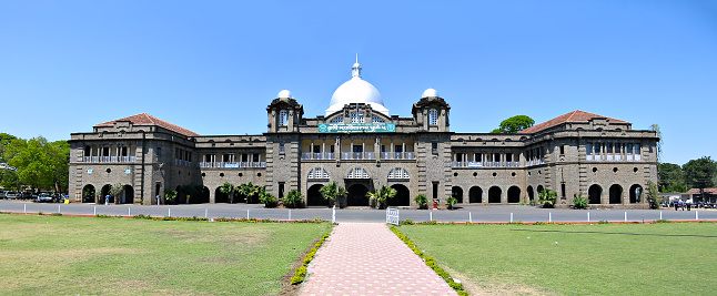 Pune, Maharashtra, India - March 12, 2005 : Panoramic image of ancient Agriculture college building. It is constructed of shaped stones.