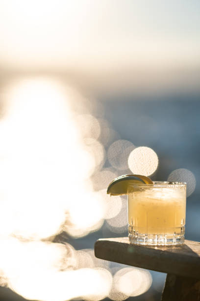 Refreshing summer juices with soda and citrus lemonade and orangeade with straws and a lemon outdoors