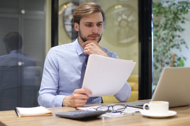 istock Successful entrepreneur is studying documents with attentive and concentrated look. 1270891232