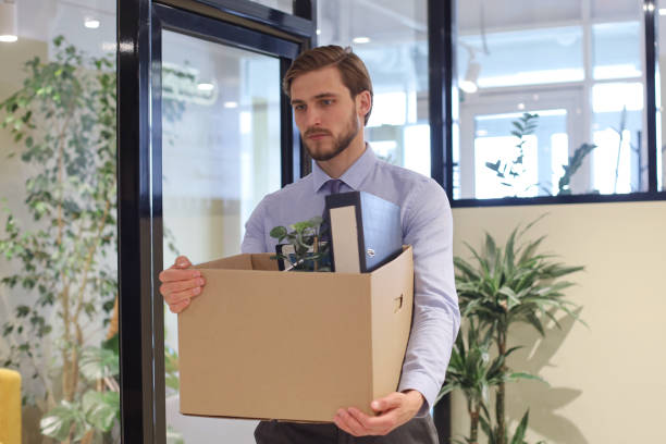 istock Dismissed worker going from the office with his office supplies. 1270891944
