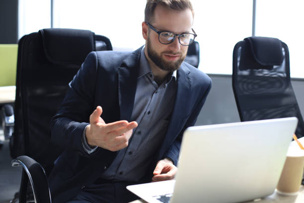 istock Smiling young business man having video call in office. 1270892756