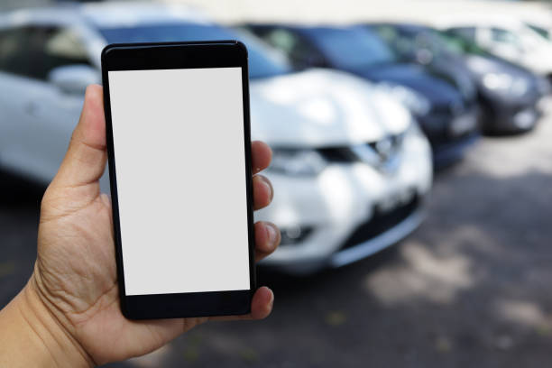 istock Man using smartphone while walking to his car at outdoor carpark 1270892814