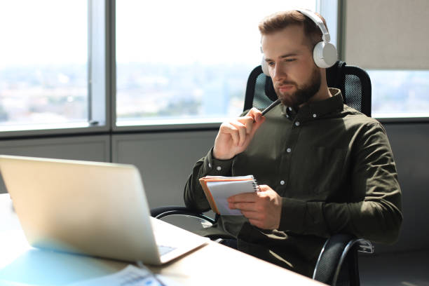 istock Young modern business man working using laptop while sitting in the office. 1270892819