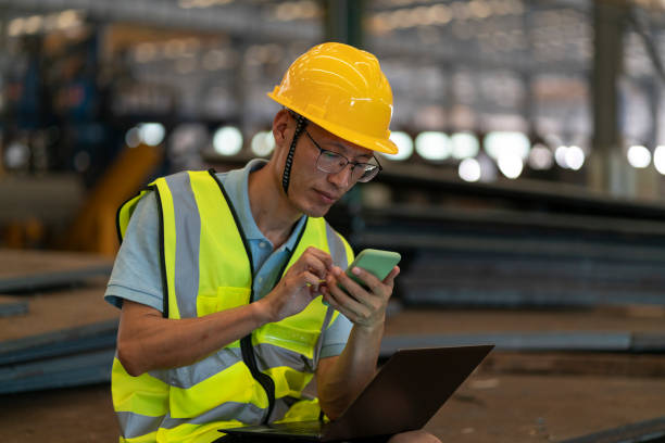 istock Factory male engineer using laptop and smartphone 1270892918