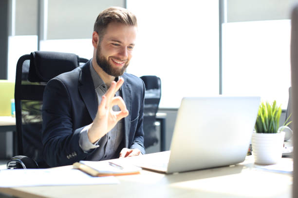 istock Smiling young business man having video call in office. 1270893005