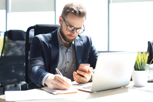 istock Businessman using his mobile phone in the office. 1270893065