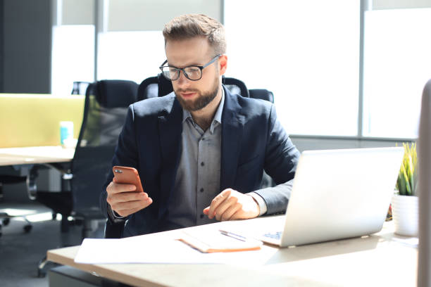 istock Businessman using his mobile phone in the office. 1270893606
