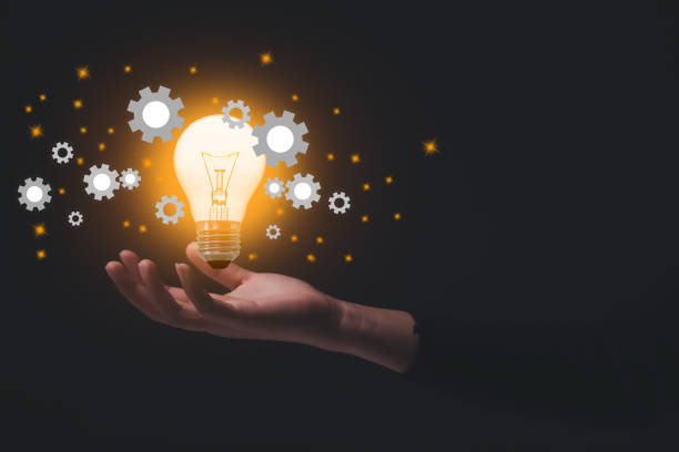 istock Hand holding illuminated light bulb and cog, idea and imagination, creative, innovation inspiration concept. 1270893751