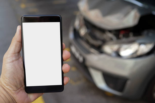 istock Close-Up Of Hand Using Smart Phone After Having Car Crash 1270893777