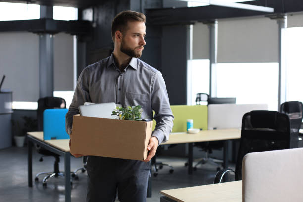istock Dismissed worker going from the office with his office supplies. 1270893824