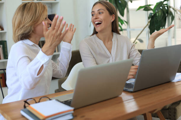 istock Two female collegues working with laptop and discussing new project. 1270894681