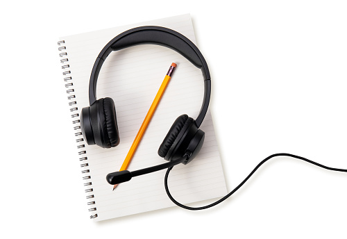 headset on a white  notebook.with clipping path.