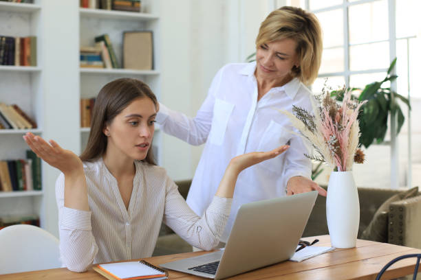 istock Two female collegues working with laptop and discussing new project. 1270895029