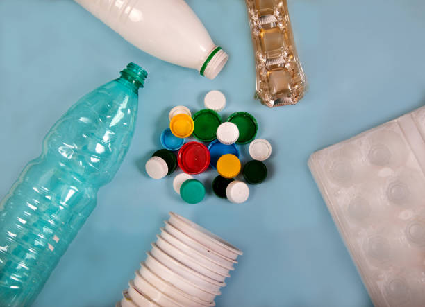 istock Waste, garbage from plastic bottles, glasses, egg packaging and lids on a blue background. 1270896868