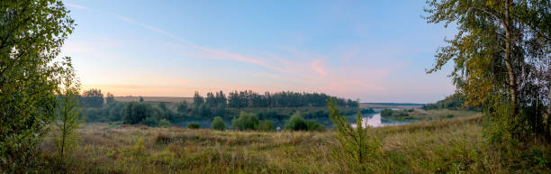 istock Panoramic view of calm lake during sunrise. 1270897683