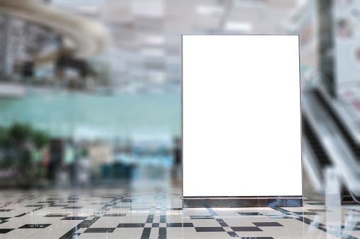 Blank advertising banner mockup in modern airport retail environment; large digital display screen. Billboard, poster, out-of-home OOH media display space.