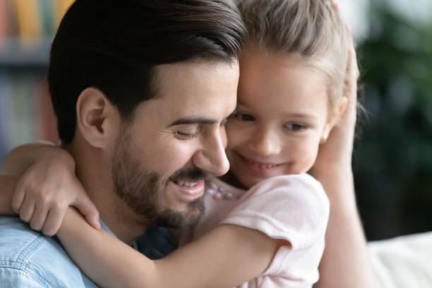 istock Close up loving young father hugging pretty little daughter 1270899417