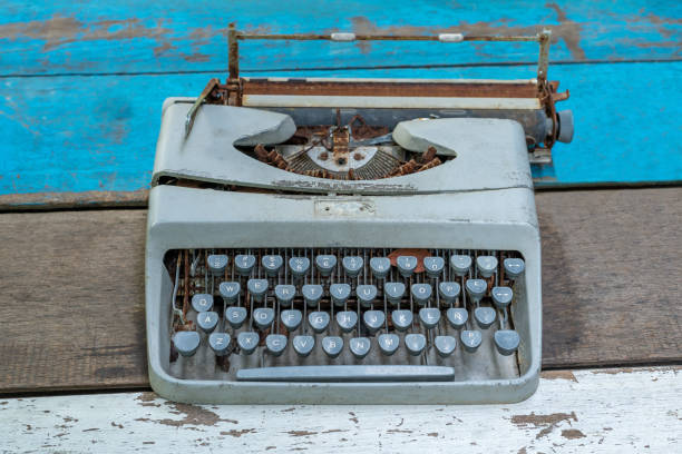 istock Blue Ancient Typewriter rusted  With three pink pig-shaped dolls on the work desk With natural views 1270901587