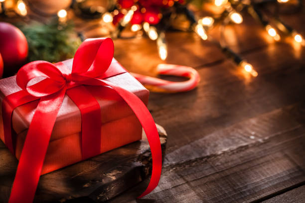istock Red Christmas gift on rustic wooden table 1270902496