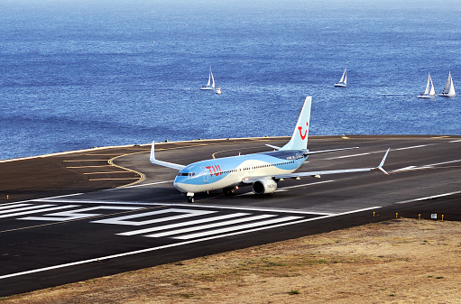 TUI Boeing 737. The Commercial jet aeroplane started the landing gear system for landing.. Airport Funchal, Madeira, Portugal. Atlantic Ocean. August 12, 2018.