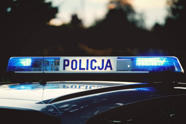 Emergency lights flashing on top of a Polish Police ("Policja") patrol car Emergency lights flashing on top of a Polish Police ("Policja") patrol car in evening scsnery poland stock pictures, royalty-free photos & images
