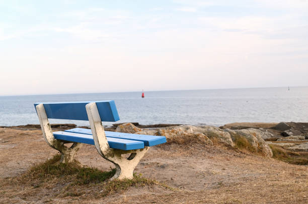 istock Empty wooden blue bench at the seashore 1270908352