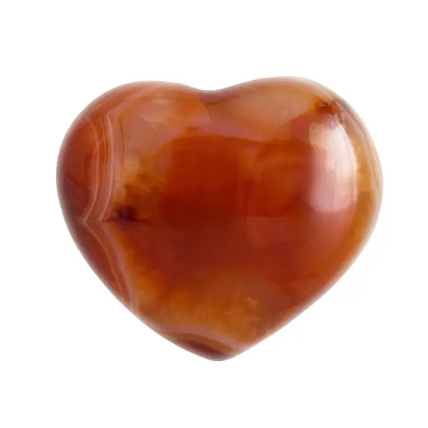 Semiprecious spiritual carnelian heart shaped stone isolated on white