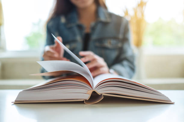 istock a woman sitting and reading book 1270911576