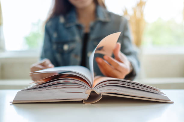 istock a woman sitting and reading book 1270911586