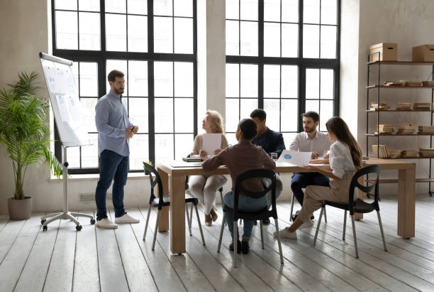 istock Skilled young speaker presenting corporate marketing strategy. 1270913412