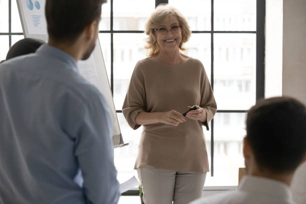 istock Happy 50s senior business trainer enjoying providing educational lecture. 1270913499
