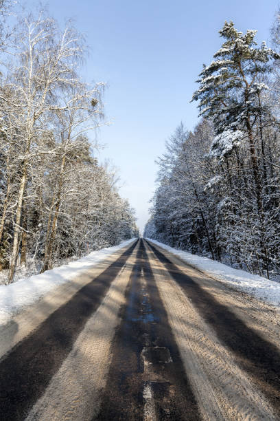 istock narrow snow-covered winter road 1270913718