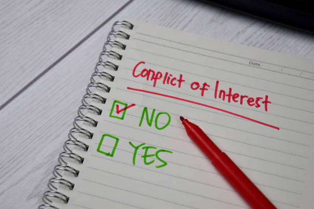istock Conflict of Interest write on a sticky note. Supported by an additional services isolated wooden table. 1270916599