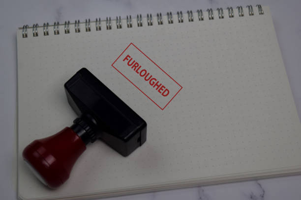istock Red Handle Rubber Stamper and Furloughed text isolated on the table. 1270917703
