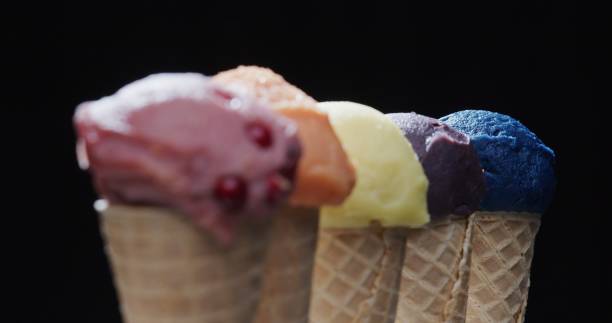 istock Row of multi-colored icecream cones on black background. Close-up 1270919084